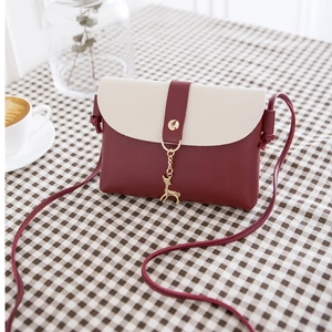 Mini bicolor PU leather crossbody bag in burgundy and beige with gold deer pendant detail