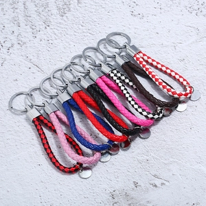 Hand-woven leather keychains in multiple colors with metallic rings and round tags