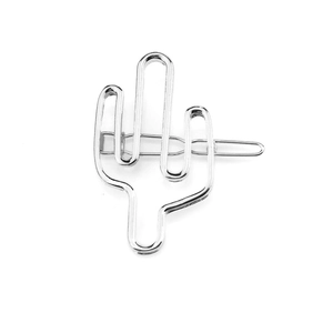 Detail view of a silver minimalist cactus shaped hair clip with a smooth metallic finish