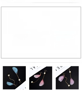 Detail of vintage style butterfly wing earrings with pearls and multiple color options