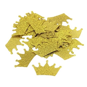 Close-up of glittery gold crown-shaped confetti for party table decoration and DIY crafts