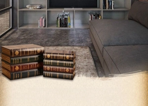 Close-up of vintage faux book storage boxes with gold-stamped spines and antique leather finish