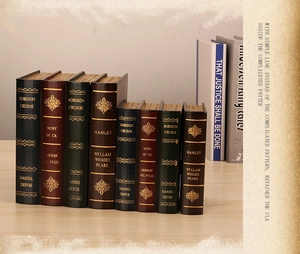 Close-up of vintage faux book storage boxes with gold-stamped spines and classic covers