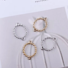 Detailed view of beaded round alloy pendants in gold and silver for DIY jewelry making