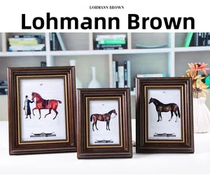 Macro detail of three vintage European style wooden photo frames in Lohmann Brown finish