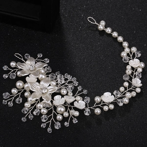 Handmade bridal hair vine with white flowers, pearls and crystals on black background