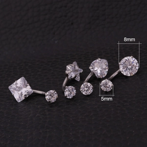 Macro shot of 316L stainless steel belly rings with silver zircons in various shapes
