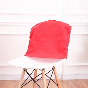 Close-up of a festive red Christmas chair cover on a white chair in a home setting