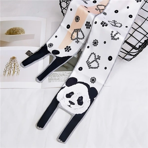 Detail of silk-like neck scarf featuring panda patterns and polka dots for women