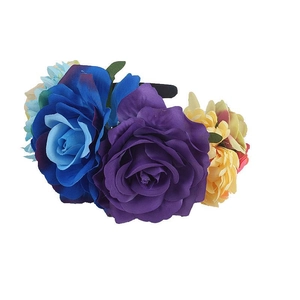 Detail of large colorful faux roses and green leaves on bohemian style headband