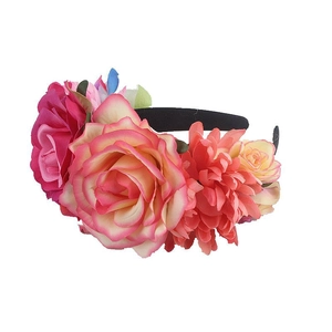 Close-up of handmade floral headband featuring colorful faux roses on a black velvet band