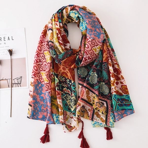Detail showing bohemian paisley print patterns and red tassels on lightweight sun scarf