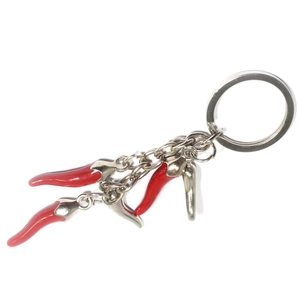 Close-up of three creative red chili pendants on a polished alloy metal keychain
