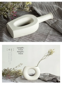 Detail of white ceramic vase with matte finish and minimalist geometric design