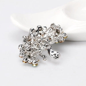 Silver tree brooch with rhinestones and cat eye stones shown from the back view