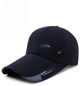 Detail of navy blue baseball cap featuring Sports Fashion print and textured cotton fabric