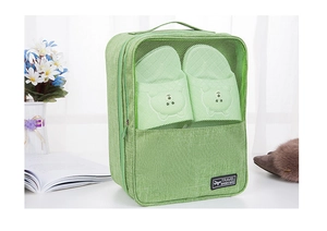 Detail view of grass green waterproof travel shoe bag with mesh window and top handle