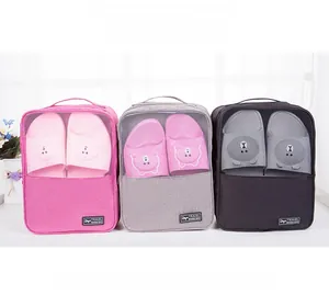 Three travel shoe bags in pink, gray and black with breathable mesh and top handle