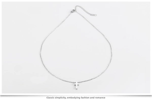 Close-up of polished silver cross pendant with adjustable chain and K18 engraving