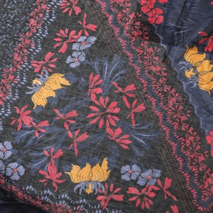 Close-up detail of dark grey cotton linen scarf with colorful floral prints and texture