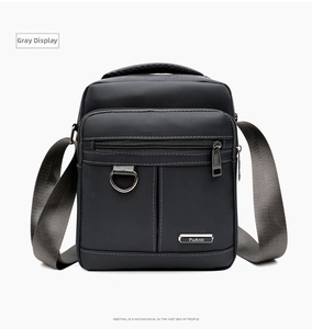 Detailed view of the dark grey waterproof Oxford fabric and PuAnti logo on the crossbody bag