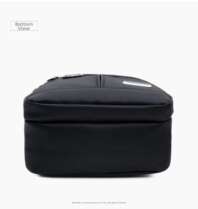 Detail view of the flat square bottom of the black nylon oxford crossbody bag for men