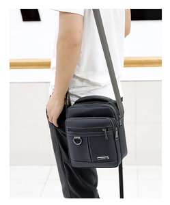 Detail view of water-resistant oxford fabric crossbody bag with adjustable strap