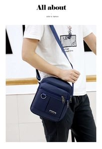 Detail shot of a navy blue waterproof oxford shoulder bag with multiple zipper compartments