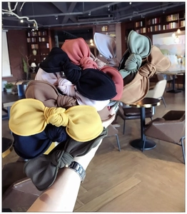 Detailed view of handmade fabric bow headbands in multiple colors like yellow and navy