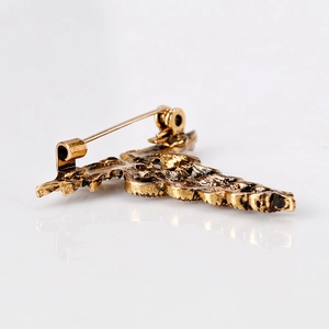 Fashionable gold alloy snake-shaped brooch with vintage texture on a white background
