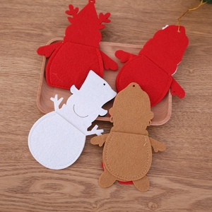 Close-up of assorted felt Christmas cutlery holders in Santa, reindeer, and snowman designs