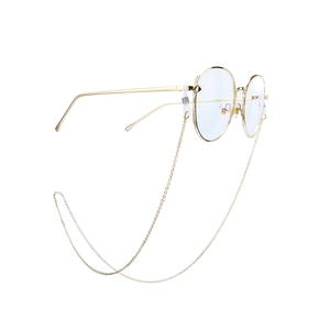 Detail of glossy gold metal eyeglasses frame with matching beaded decorative chain strap