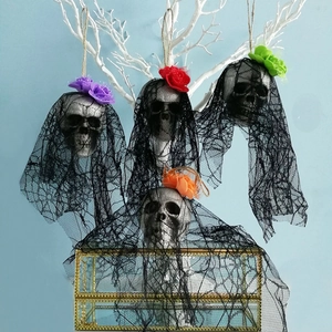 Halloween skull head prop with black lace veil and vibrant colorful floral accents