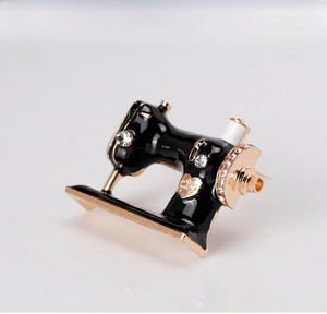 Detailed macro view of creative vintage sewing machine brooch with rhinestones
