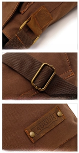 Detail of vintage canvas bag featuring leather reinforcements and antique hardware buckles