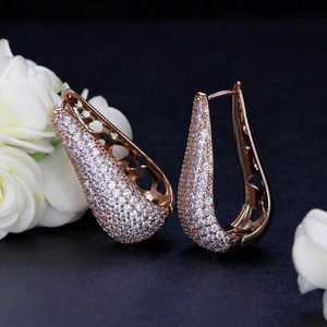 Macro shot of rose gold pear-shaped earrings with micro-pave white zircon stones