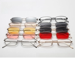 Detailed macro view of narrow rectangular metal eyeglass frames in various lens colors