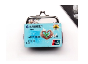 Retro landscape print coin purse size comparison with a card on white background