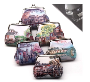 Detail view of vintage coin purses with traditional landscape prints and metal kiss locks