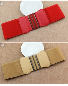 Detail of red and khaki wide elastic waist belts with double oval metal buckles