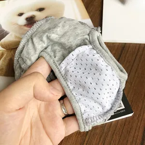 Close-up of pet diaper showing breathable white honeycomb mesh lining and gray fabric