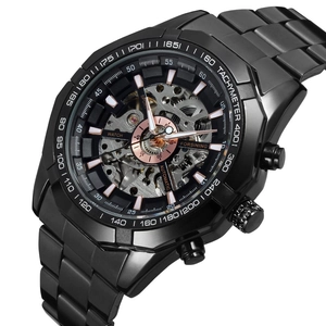 Macro detail of the black hollow automatic mechanical watch with rose gold dial accents