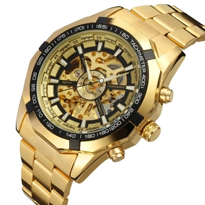 Detailed macro view of gold automatic mechanical watch with skeleton dial and tachymeter