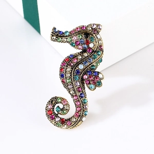 Detailed close-up of vintage gold seahorse brooch with vibrant multi-color rhinestones