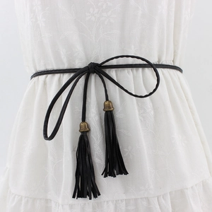 Women's black PU braided thin waist belt with tassel and bronze bell on white dress