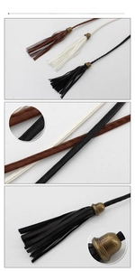 Detail view of woven PU leather waist belts with tassel ends and vintage bronze hardware