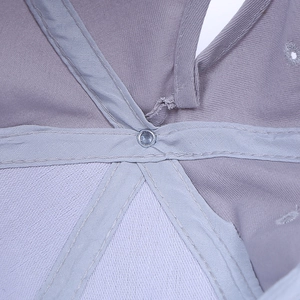 Detail shot of the interior stitching and metal rivet on a light purple baseball cap
