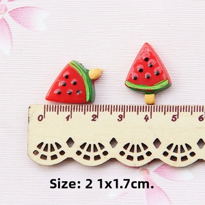 Detailed size view of resin watermelon charms for DIY jewelry on a wooden ruler