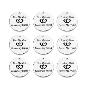 Macro view of nine stainless steel round charms engraved with First My Mom Forever My Friend