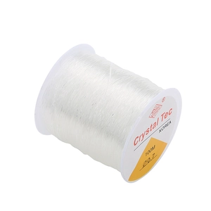 Detailed view of 0.7mm clear elastic beading cord on a 100m spool for DIY jewelry making